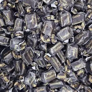 Individually wrapped traditional liquorice flavour chewy toffees in a black and gold wrapper