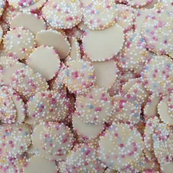 white chocolate buttons with multicoloured sprinkles on top