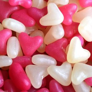 Pink and white jelly bean sweets in the shape of love hearts