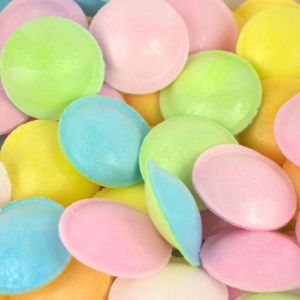 Multicoloured edible paper discs filled with sour sherbet powder
