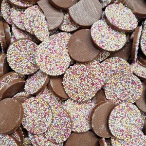 Hannahs mega jazzies are milk chocolate flavour discs with multicoloured sprinkles on top