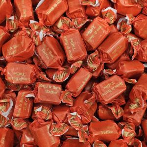 Individually wrapped traditional rum and butter flavour chewy toffees in a red and gold wrapper